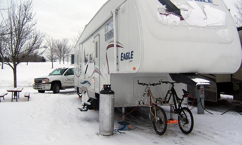an rv covered in snow in the winter