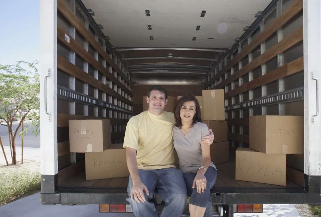 a couple packing up their home to move