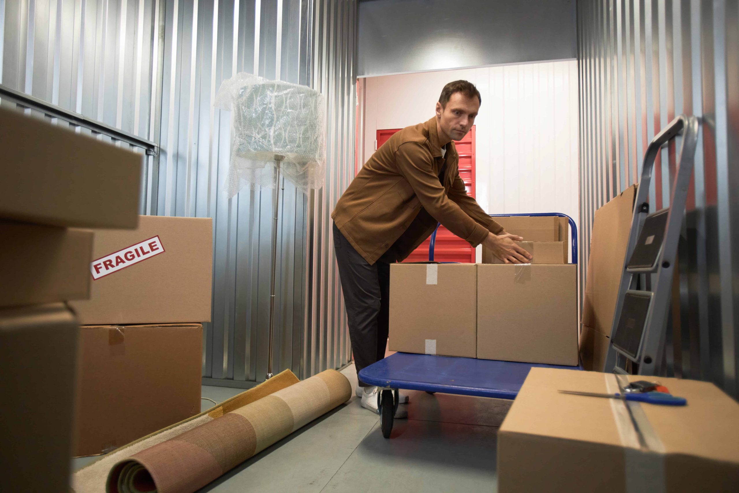 Man moving boxes into a storage unit in Ottawa